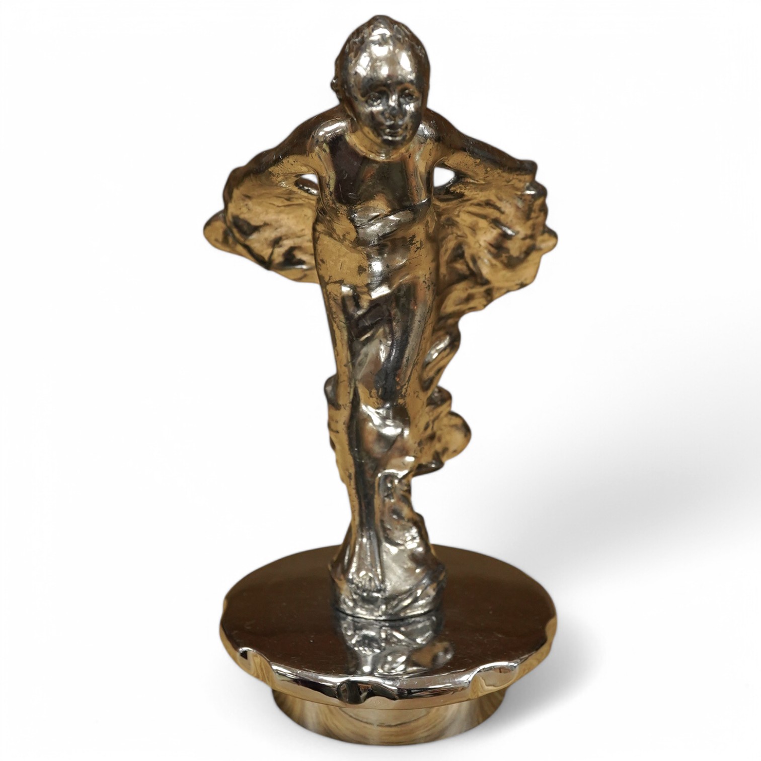 A Sykes style chromed car mascot in the form of an Art Deco woman with flowing gown, indistinctly signed to the base and dated 1922, mounted on a threaded radiator cap. Condition - fair to good.